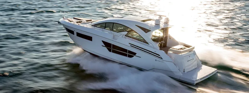  Yacht Photos Pics 2021 Cruisers Yachts 60 Cantius cruising on open water at sunset.