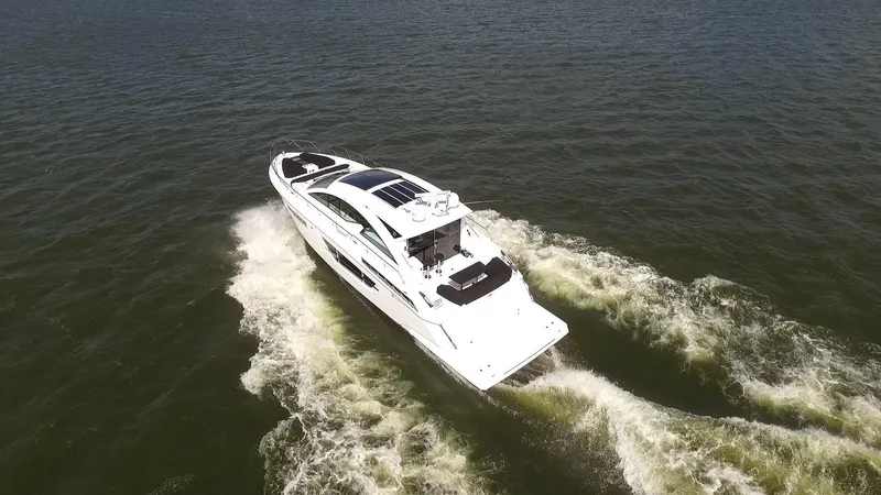  Yacht Photos Pics 2021 Cruisers Yachts 60 Cantius cruising on open water, aerial view.