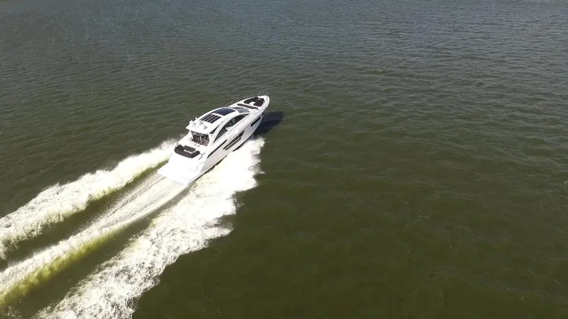 Yacht Photos Pics 2021 Cruisers Yachts 60 Cantius cruising on open water, aerial view.