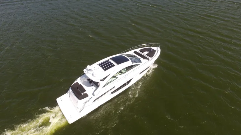  Yacht Photos Pics 2021 Cruisers Yachts 60 Cantius cruising on open water, aerial view.