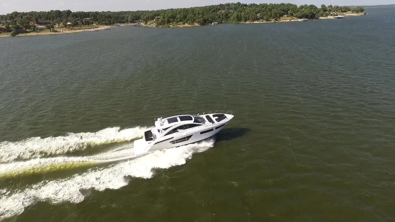  Yacht Photos Pics 2021 Cruisers Yachts 60 Cantius cruising on a scenic lake.