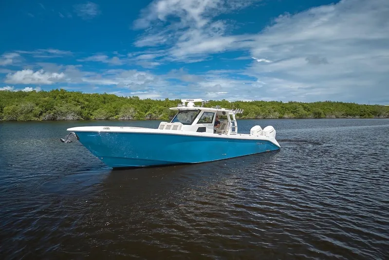 Tropical Moon Yacht Photos Pics 2022 Solace 41 CS boat cruising on a calm river under a blue sky.