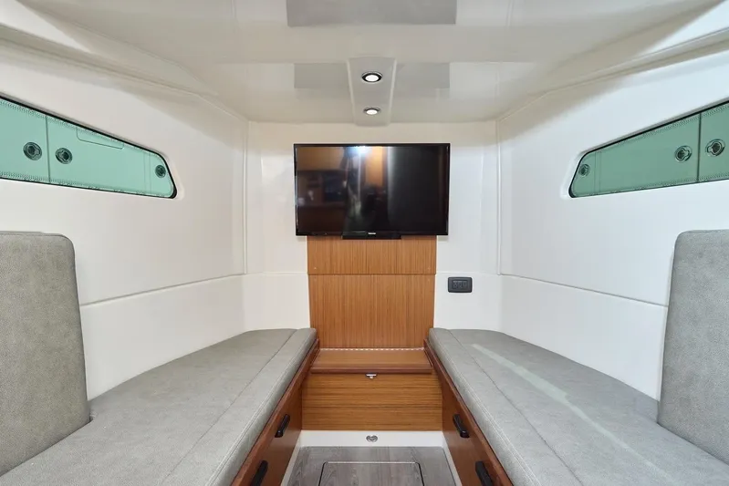 Tropical Moon Yacht Photos Pics Interior of 2022 Solace 41 CS boat with TV and seating area.