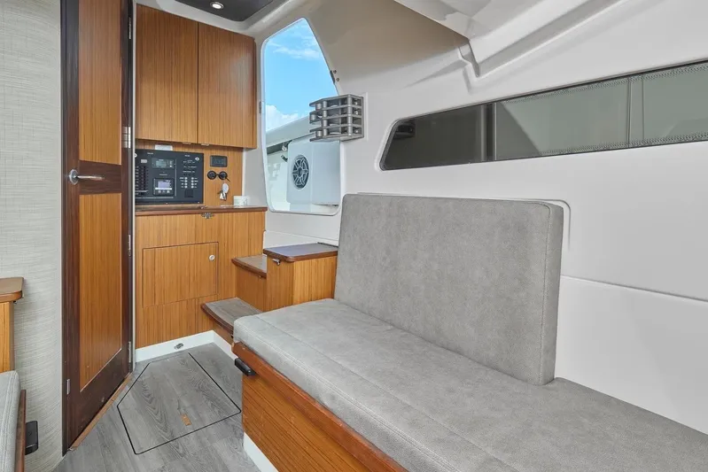 Tropical Moon Yacht Photos Pics Interior of 2022 Solace 41 CS boat with wooden cabinetry and gray seating.