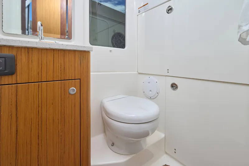 Tropical Moon Yacht Photos Pics 2022 Solace 41 CS boat bathroom with wooden cabinetry and modern fixtures.