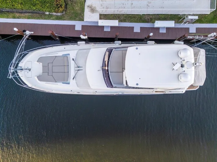 59' 2020 Prestige 590 Flybridge Yacht Photos Pics Aerial view of a 2020 Prestige 590 flybridge yacht docked at a marina.