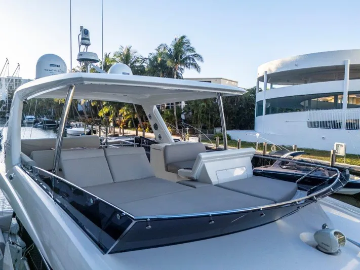 59' 2020 Prestige 590 Flybridge Yacht Photos Pics Prestige 590 Flybridge 2020 yacht with spacious deck and modern design, docked near palm trees.