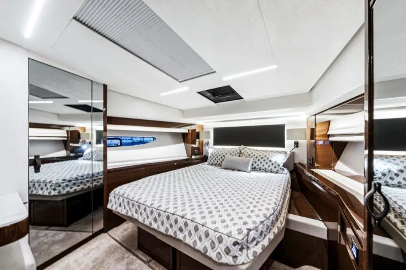 59' 2020 Prestige 590 Flybridge Yacht Photos Pics Luxurious bedroom interior of 2020 Prestige 590 flybridge yacht with modern design and elegant furnishings.