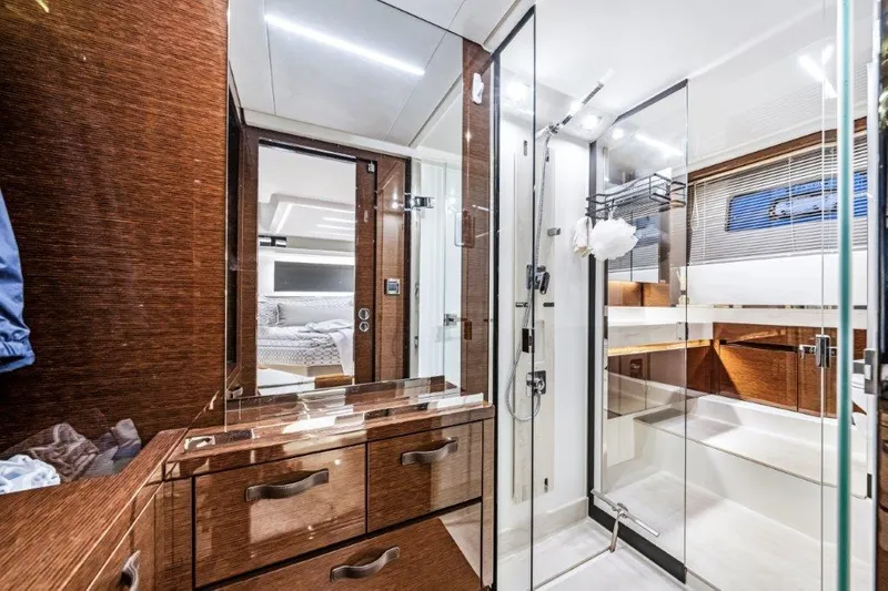 59' 2020 Prestige 590 Flybridge Yacht Photos Pics Luxurious bathroom interior of 2020 Prestige 590 Flybridge yacht, featuring sleek wood and glass design.