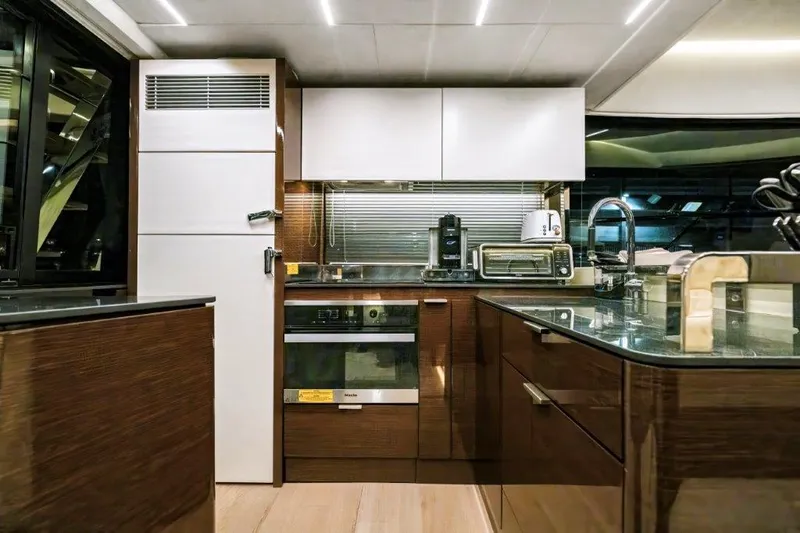 59' 2020 Prestige 590 Flybridge Yacht Photos Pics Modern kitchen interior on 2020 Prestige 590 flybridge yacht, featuring sleek cabinetry and appliances.