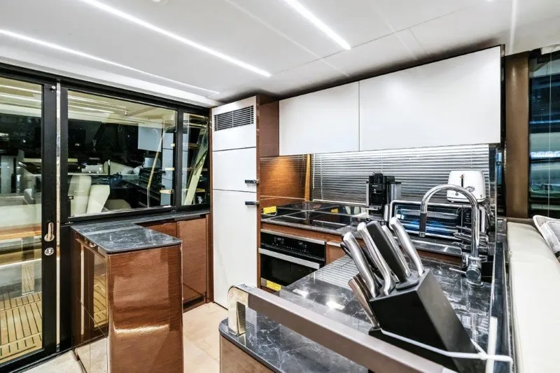 59' 2020 Prestige 590 Flybridge Yacht Photos Pics Luxurious kitchen interior of 2020 Prestige 590 flybridge yacht with modern appliances.