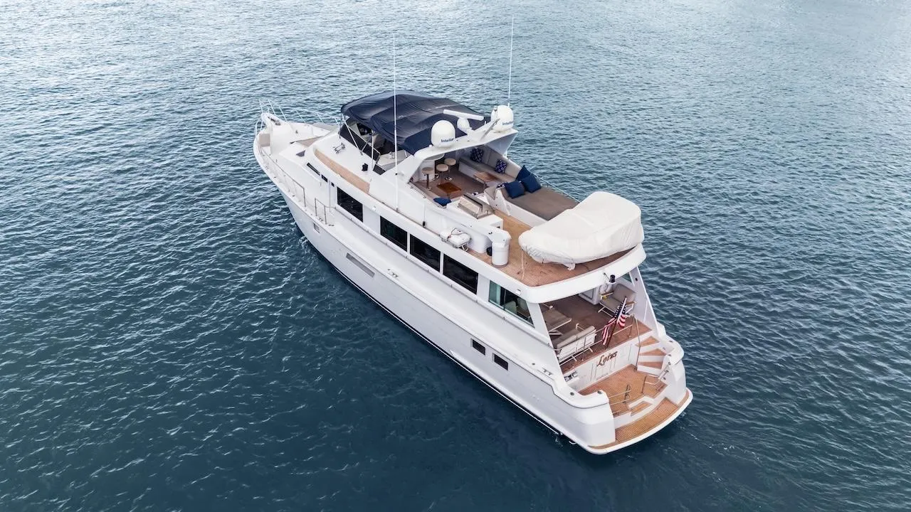 1998 Hatteras 74 Sport Deck Motor Yacht cruising on open water.