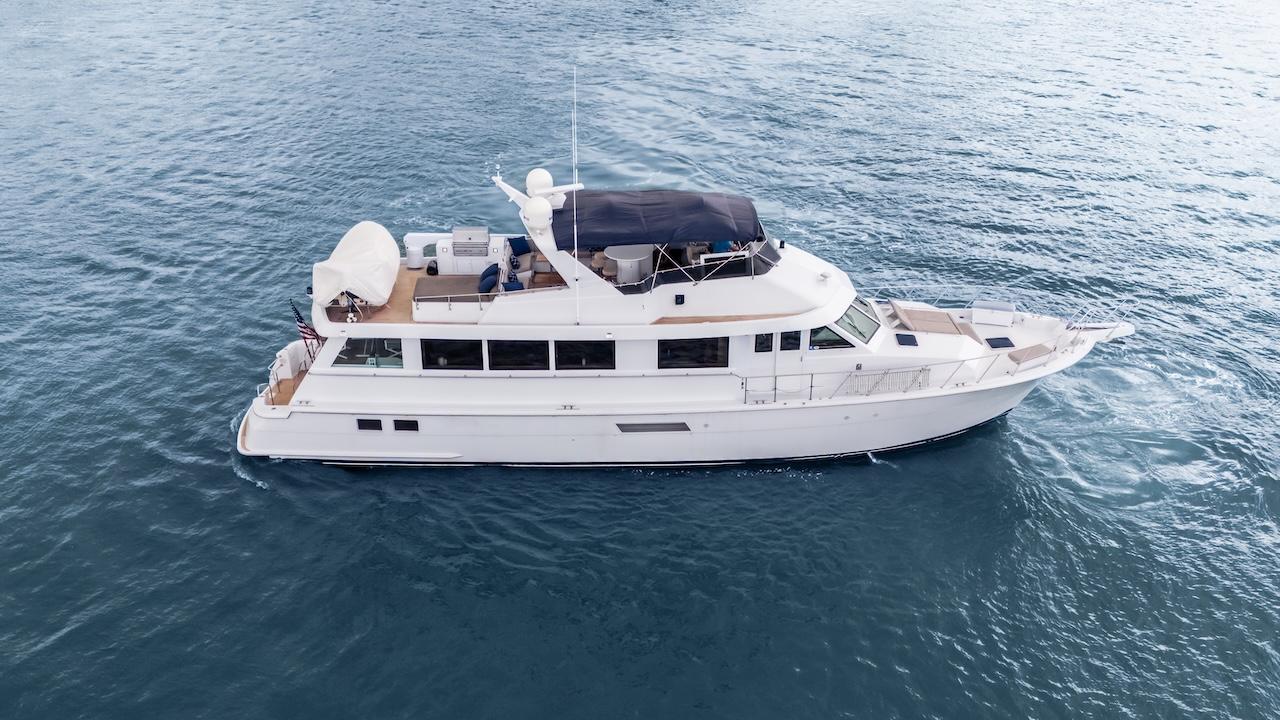1998 Hatteras 74 Sport Deck Motor Yacht cruising on open water.