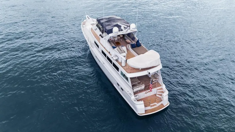  Yacht Photos Pics 1998 Hatteras 74 Sport Deck Motor Yacht cruising on open water.