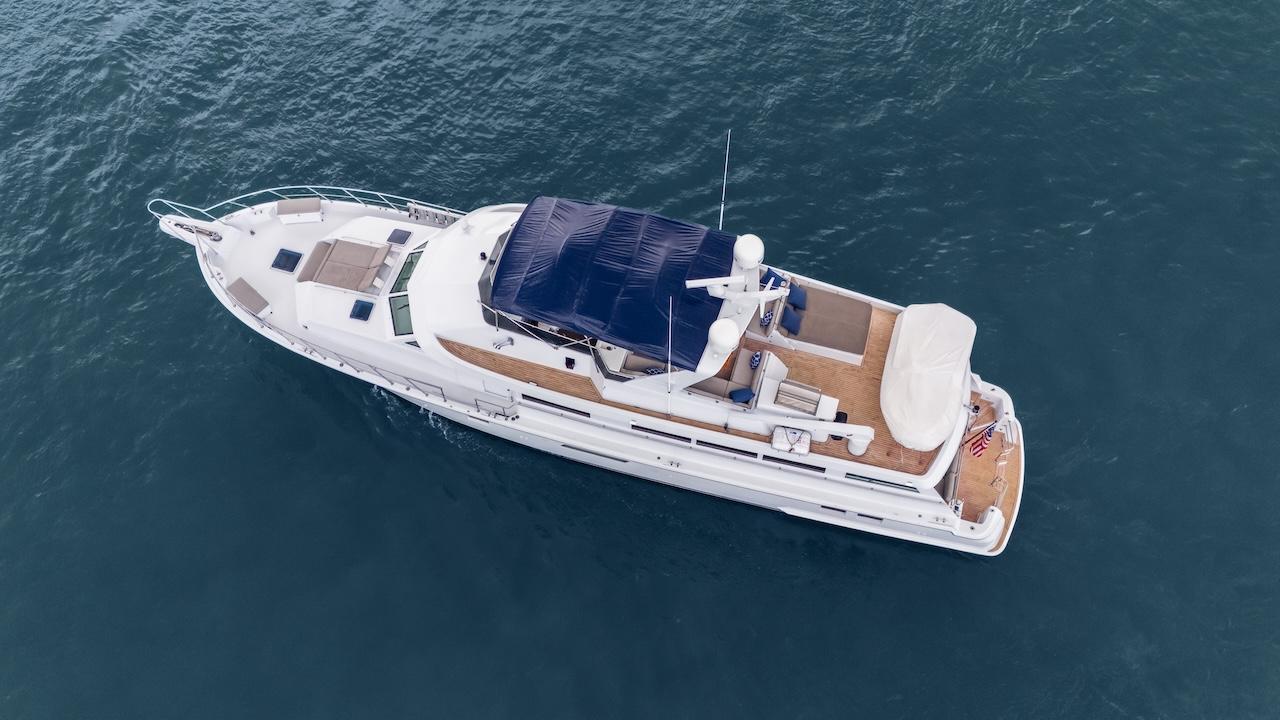 1998 Hatteras 74 Sport Deck Motor Yacht on open water, aerial view.