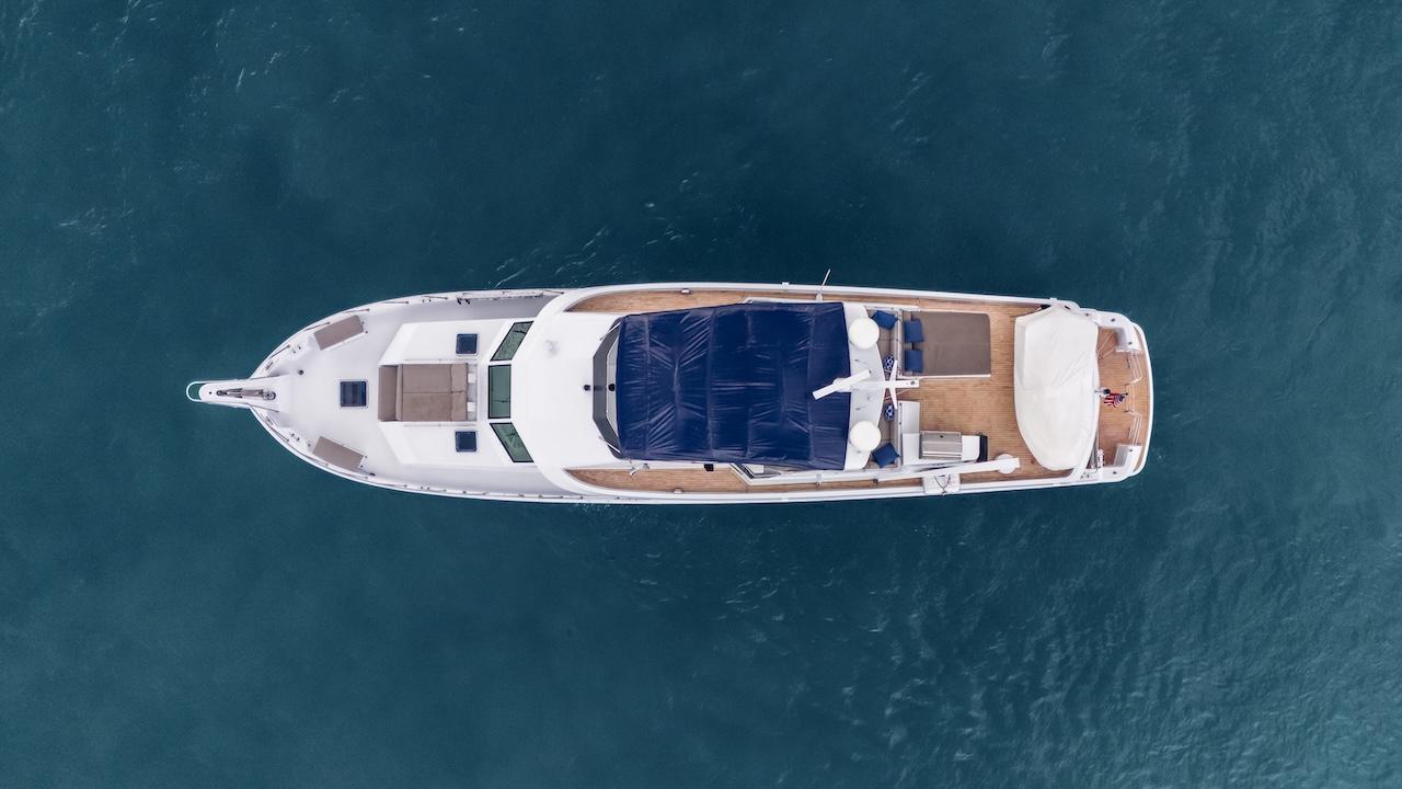 Aerial view of 1998 Hatteras 74 Sport Deck Motor Yacht on blue water.