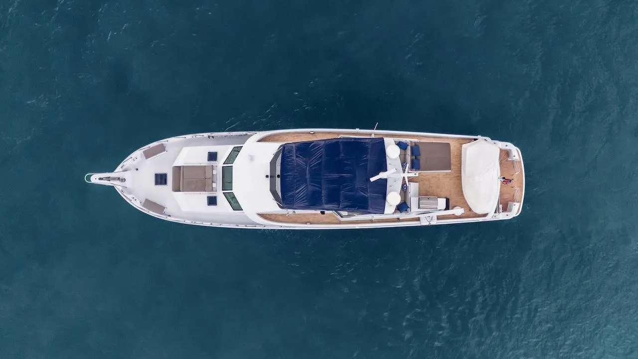 Aerial view of 1998 Hatteras 74 Sport Deck Motor Yacht on blue water.