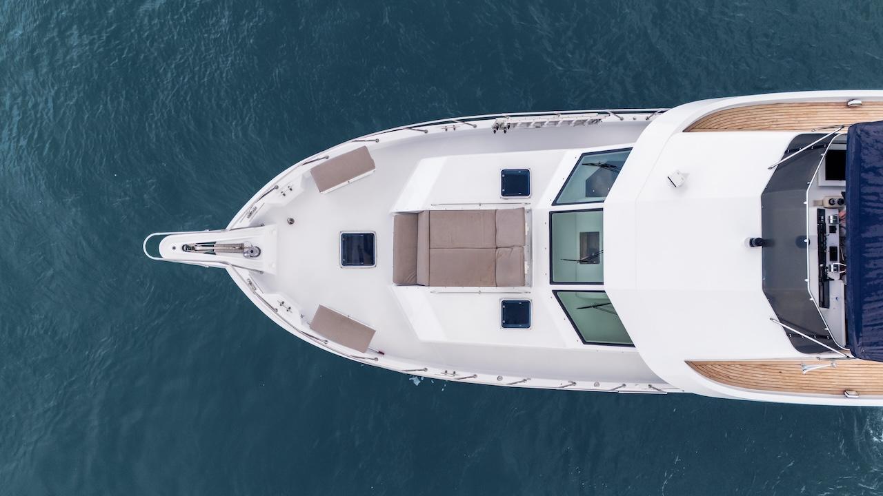 Aerial view of 1998 Hatteras 74 Sport Deck Motor Yacht on blue water.