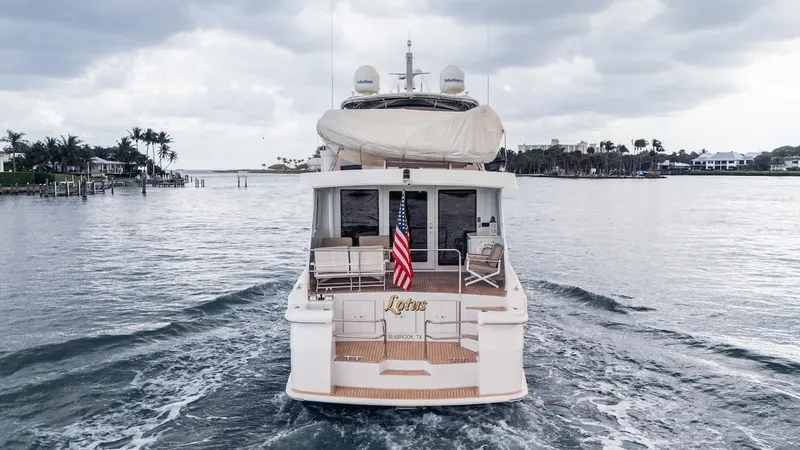 Yacht Photos Pics 1998 Hatteras 74 Sport Deck Motor Yacht cruising on a cloudy day.
