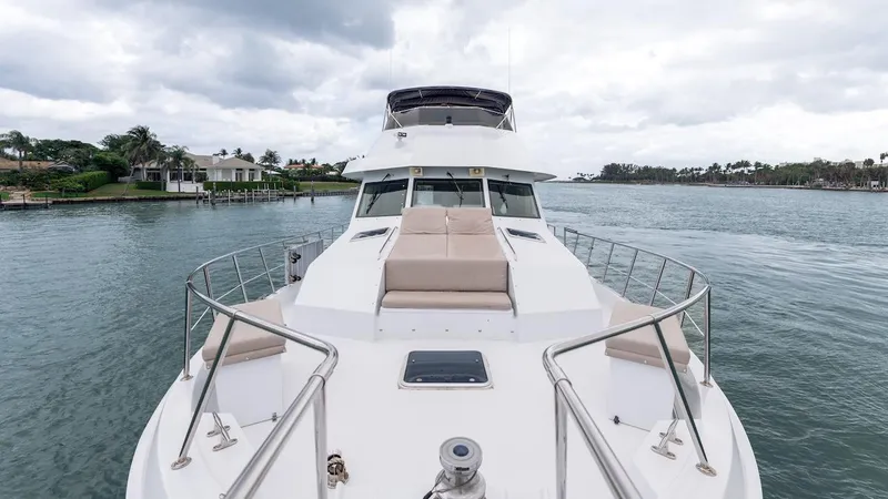  Yacht Photos Pics 1998 Hatteras 74 Sport Deck Motor Yacht on calm water, featuring spacious deck and seating.