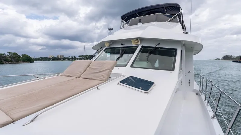  Yacht Photos Pics 1998 Hatteras 74 Sport Deck Motor Yacht on water under cloudy sky.