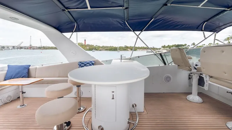  Yacht Photos Pics 1998 Hatteras 74 Sport Deck Motor Yacht with covered seating area and ocean view.