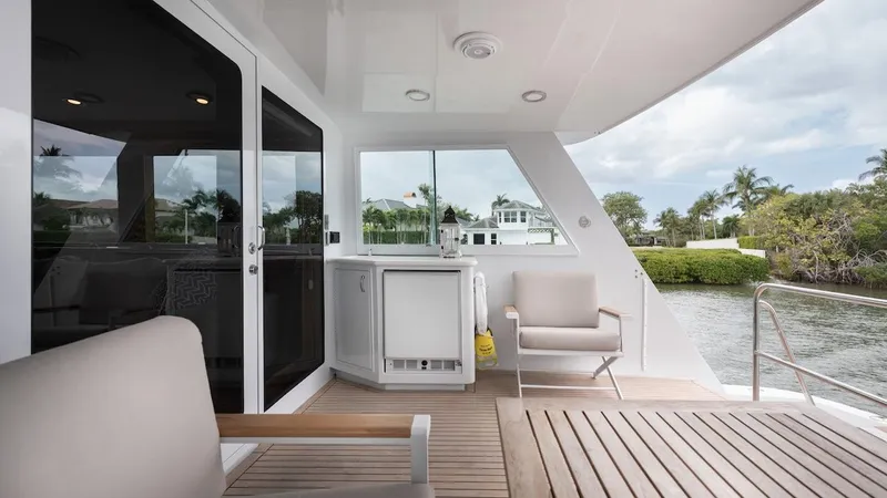  Yacht Photos Pics 1998 Hatteras 74 Sport Deck Motor Yacht, elegant outdoor seating with scenic waterway view.