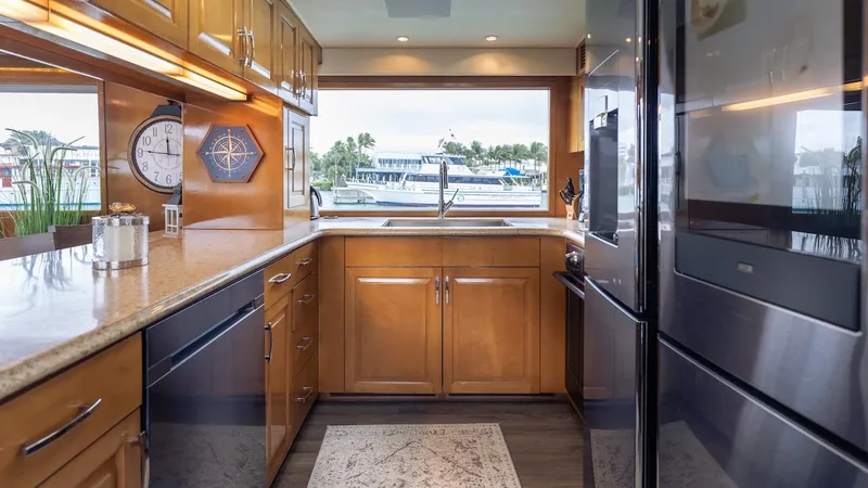  Yacht Photos Pics Luxurious kitchen interior of 1998 Hatteras 74 Sport Deck Motor Yacht with modern appliances.