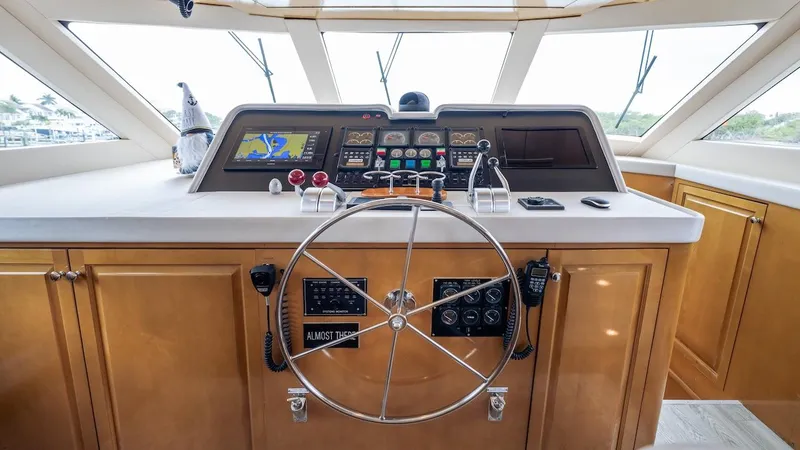  Yacht Photos Pics Helm of 1998 Hatteras 74 Sport Deck Motor Yacht with navigation controls and steering wheel.