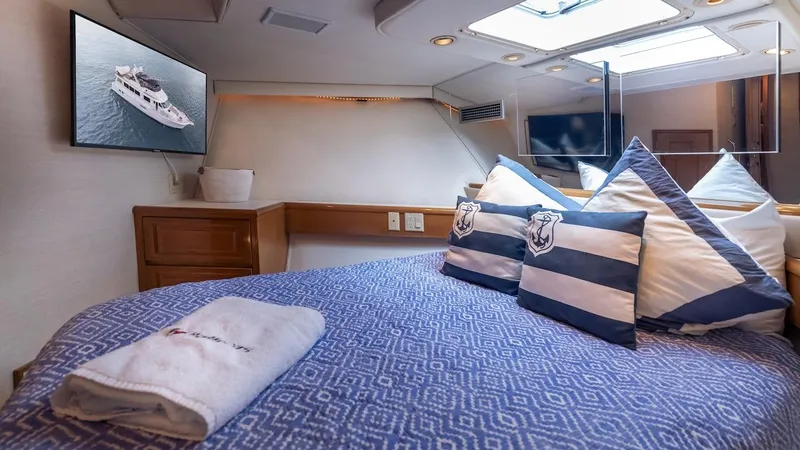  Yacht Photos Pics Luxurious bedroom interior of 1998 Hatteras 74 Sport Deck Motor Yacht with nautical decor.