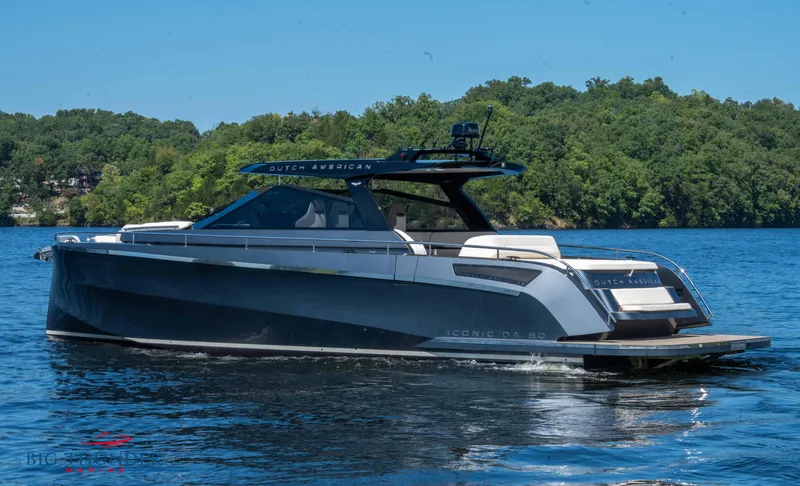  Yacht Photos Pics 2024 Dutch American Iconic DA 50 yacht on a serene lake with lush green backdrop.