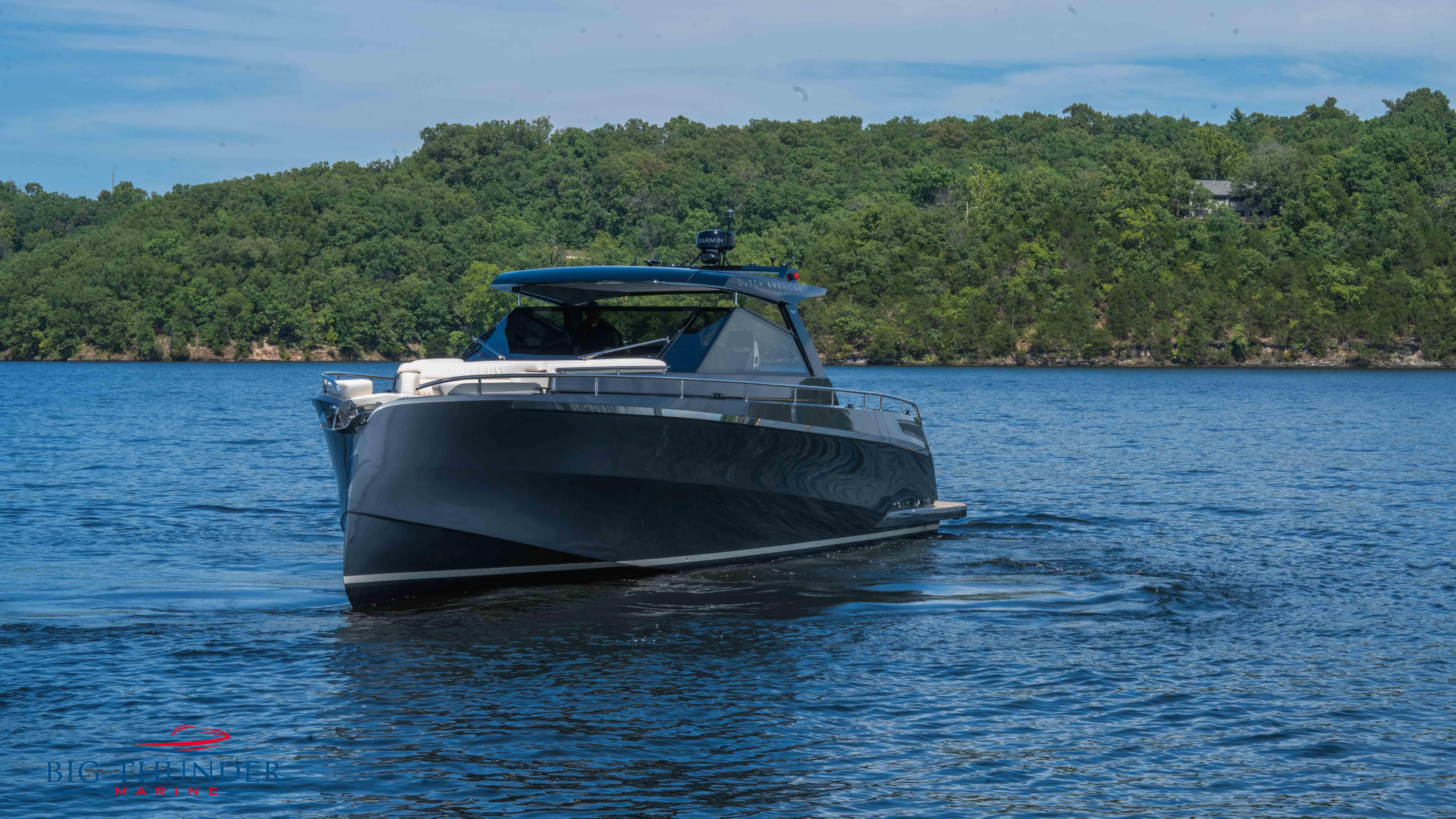 2024 Dutch American Iconic DA 50 yacht cruising on a serene lake.