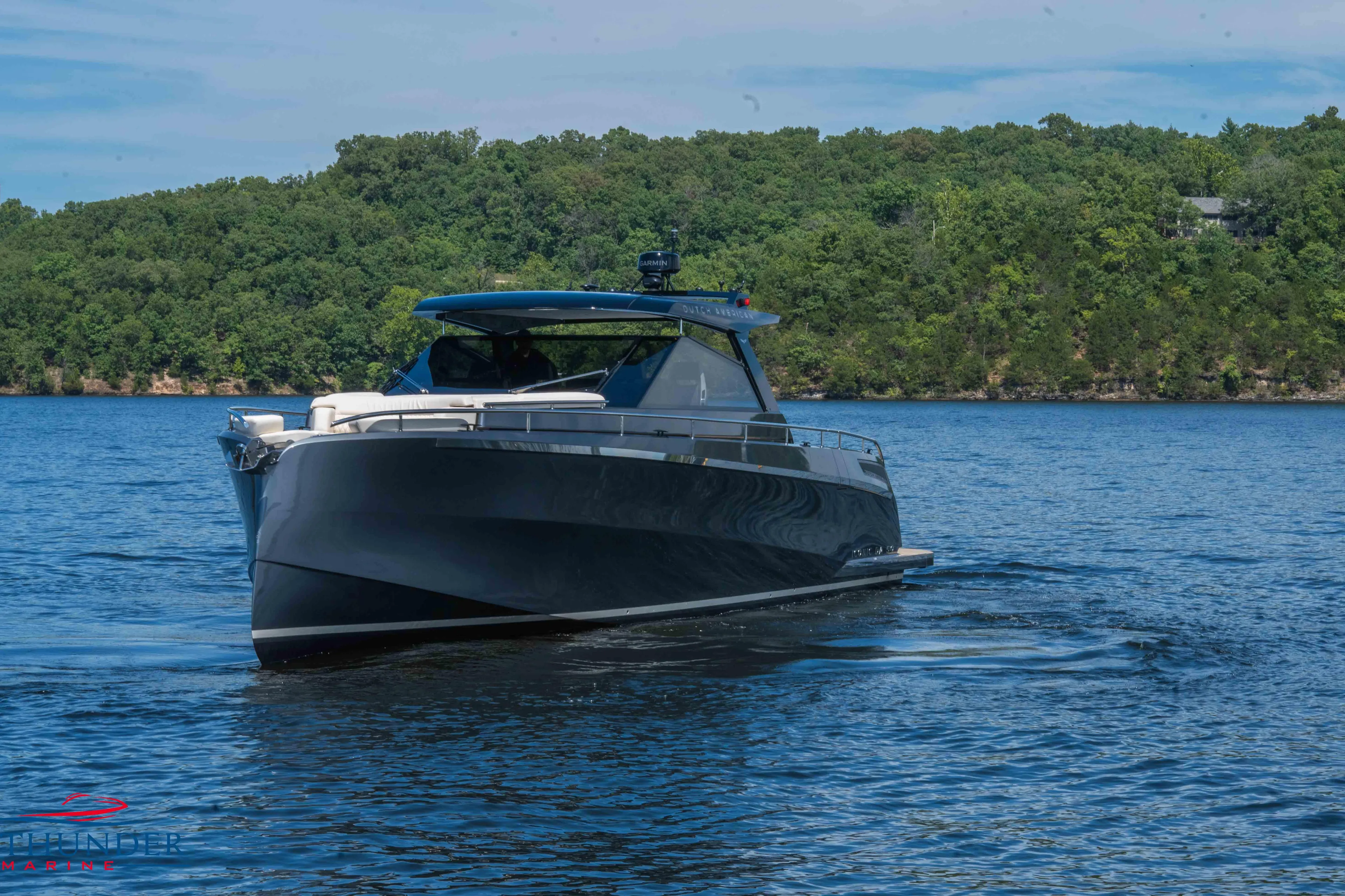 2024 Dutch American Iconic DA 50 yacht cruising on a serene lake.