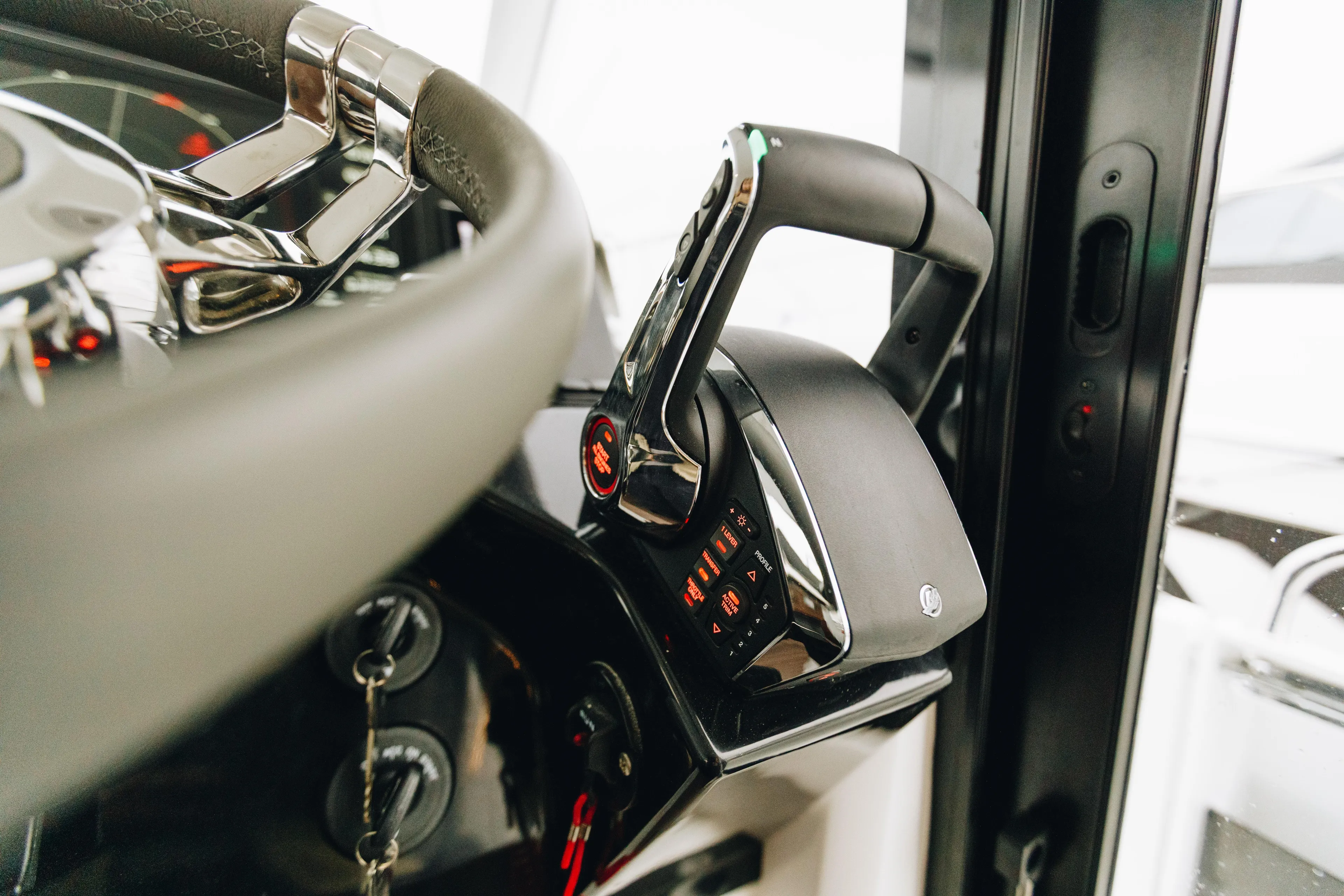  Yacht Photos Pics Close-up of 2026 Beneteau Antares 11 Fly steering wheel and throttle controls.