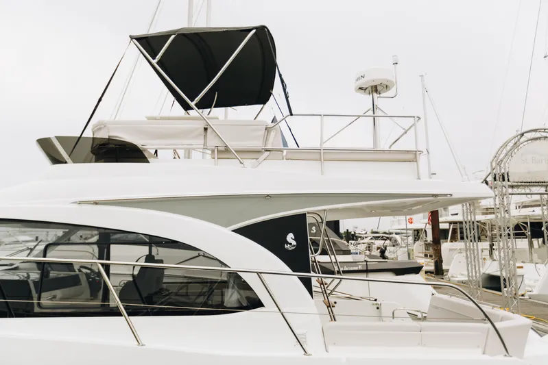  Yacht Photos Pics 2026 Beneteau Antares 11 Fly yacht docked at marina, showcasing sleek design and flybridge.