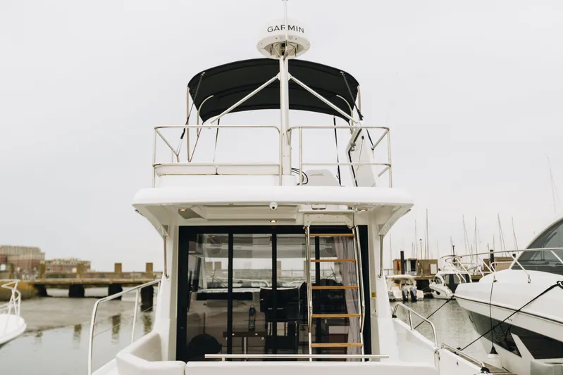  Yacht Photos Pics 2026 Beneteau Antares 11 Fly yacht, rear view, docked in marina.