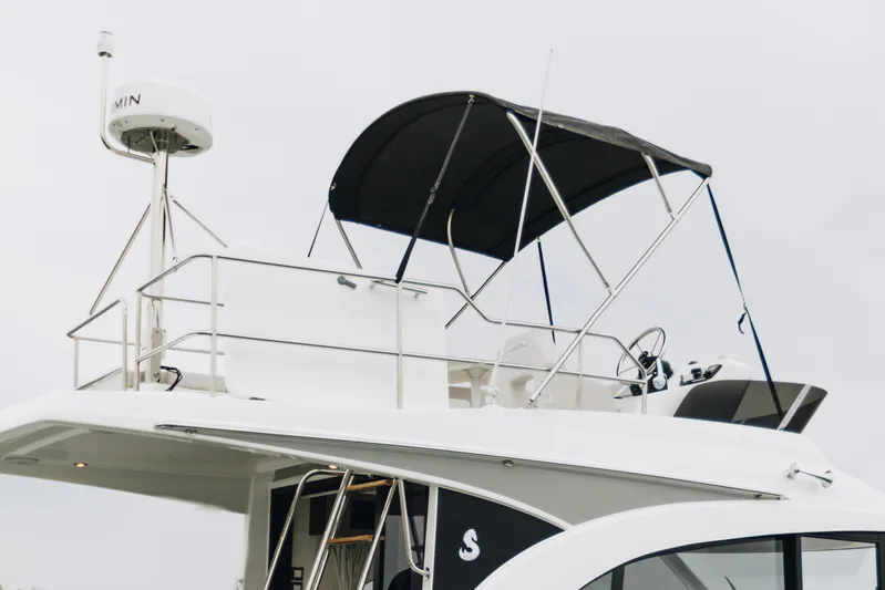  Yacht Photos Pics 2026 Beneteau Antares 11 Flybridge with radar and canopy, side view.