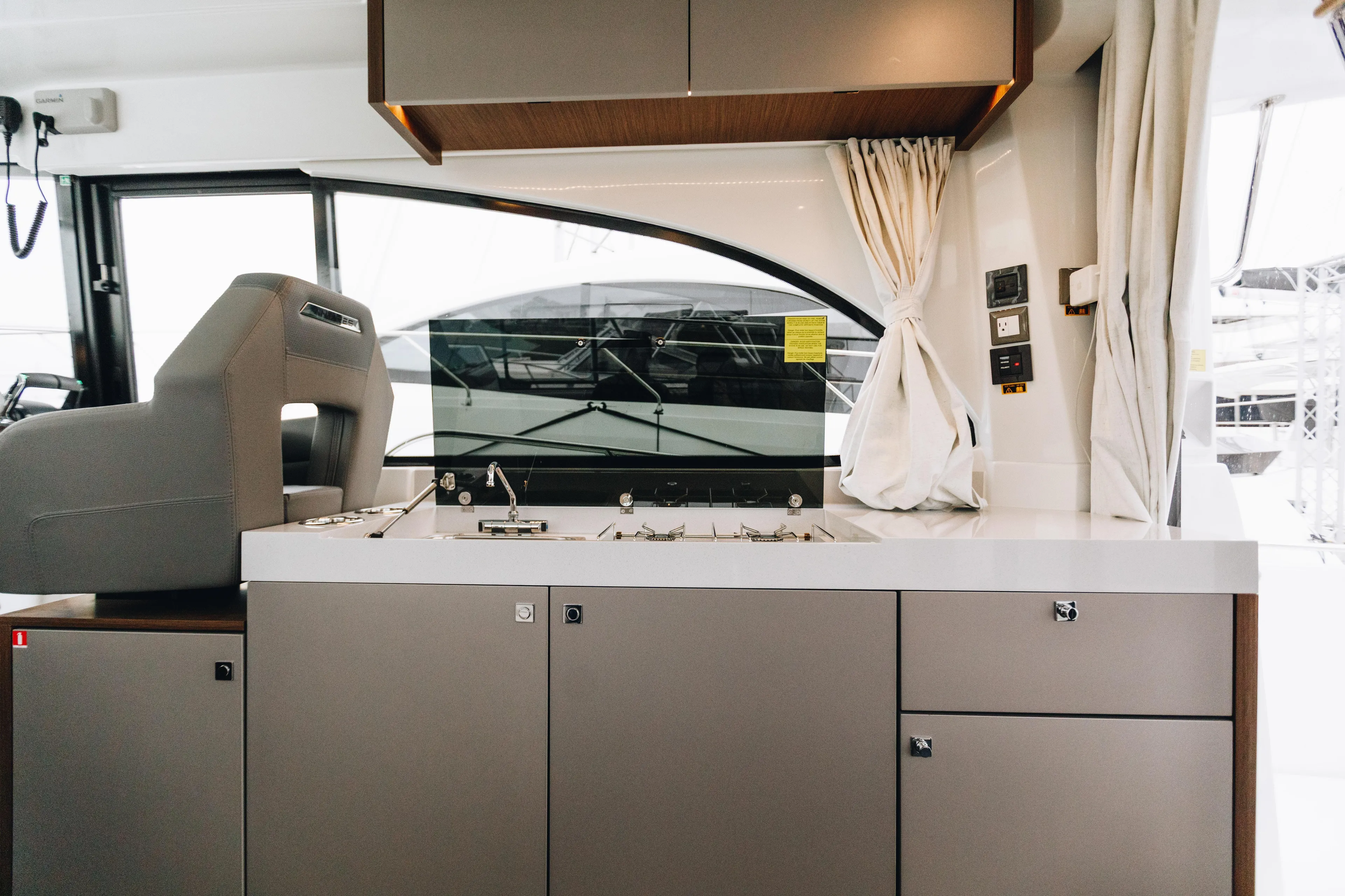  Yacht Photos Pics Interior of 2026 Beneteau Antares 11 Fly yacht, featuring modern kitchen and helm station.