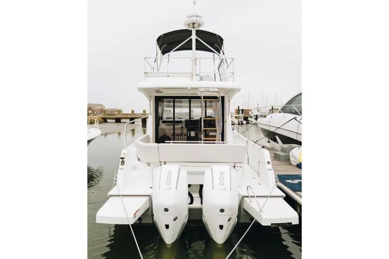  Yacht Photos Pics 2026 Beneteau Antares 11 Fly yacht with dual outboard engines docked at marina.