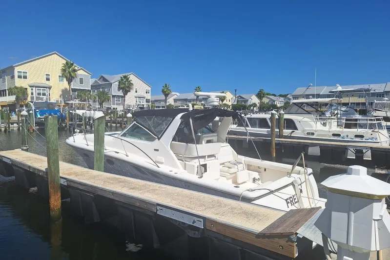  Yacht Photos Pics 2002 Tiara 3500 Open yacht docked at a marina with waterfront homes in the background.