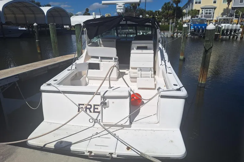  Yacht Photos Pics 2002 Tiara 3500 Open boat docked at marina, rear view with seating and equipment.