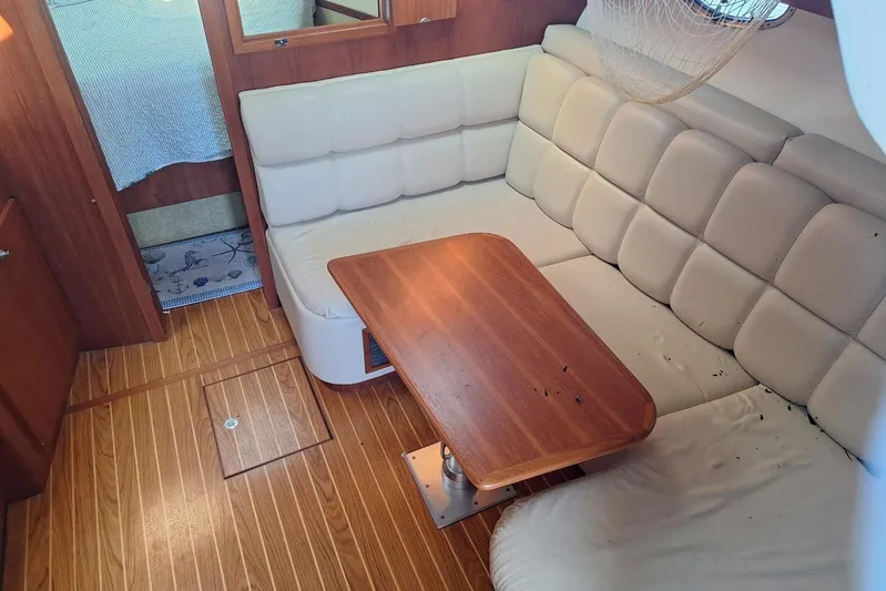 Yacht Photos Pics Interior of 2002 Tiara 3500 Open yacht with cushioned seating and wooden table.