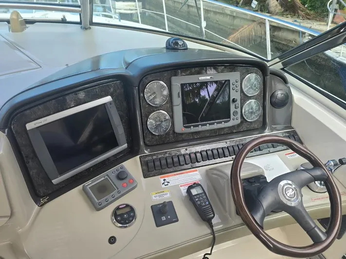  Yacht Photos Pics Dashboard of a 2008 Sea Ray 40 Sundancer with navigation equipment and steering wheel.