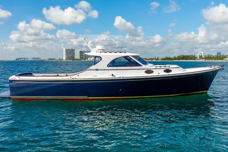 Volatility Yacht Photos Pics 2003 San Juan SJ 38 yacht on blue water under a partly cloudy sky.