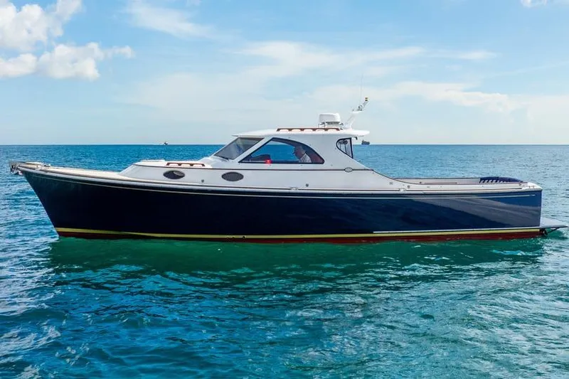 Volatility Yacht Photos Pics 2003 San Juan SJ 38 yacht on calm blue ocean under clear sky.