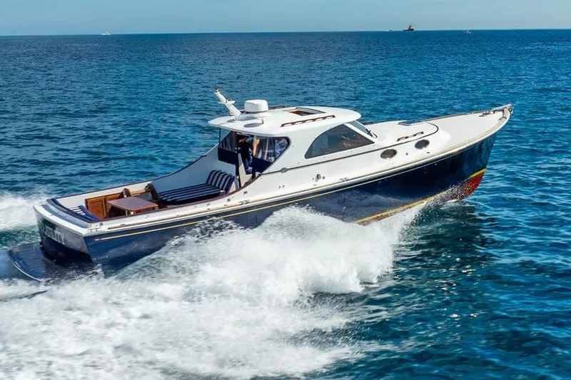 Volatility Yacht Photos Pics 2003 San Juan SJ 38 yacht cruising on open sea, creating white waves.