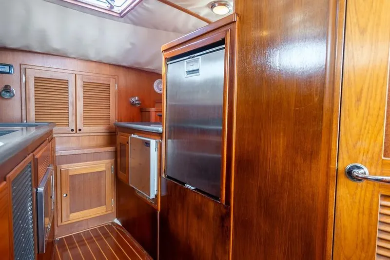 Volatility Yacht Photos Pics Interior of 2003 San Juan SJ 38 yacht with wooden cabinetry and stainless steel appliances.