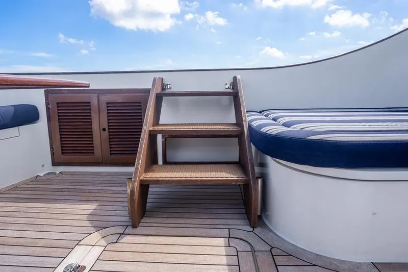 Volatility Yacht Photos Pics Wooden deck and steps on 2003 San Juan SJ 38 boat under blue sky.