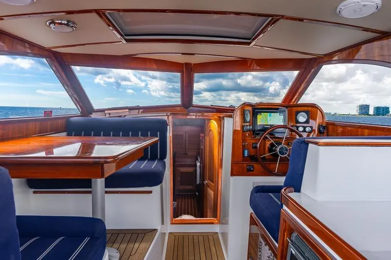 Volatility Yacht Photos Pics Luxurious 2003 San Juan SJ 38 yacht interior with wooden finishes and ocean view.