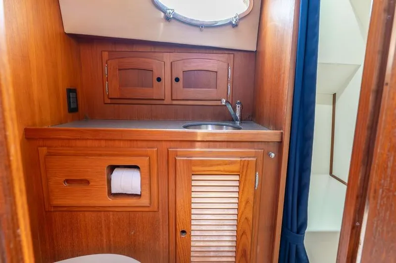 Volatility Yacht Photos Pics Wooden bathroom interior of 2003 San Juan SJ 38 yacht with sink and storage.